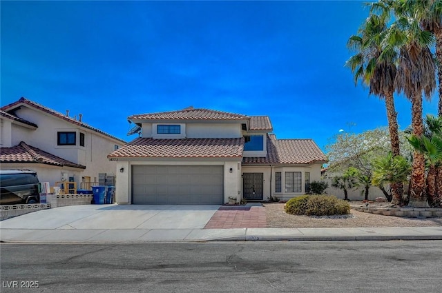 mediterranean / spanish-style home with a garage