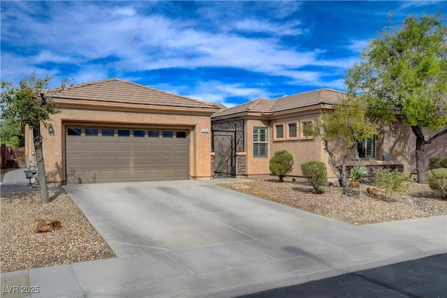 view of front of property featuring stucco siding, concrete driveway, and a tiled roof