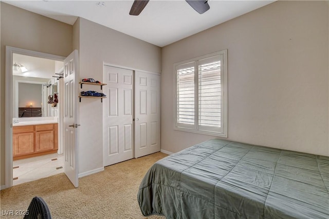 bedroom featuring light carpet, ceiling fan, a closet, and baseboards