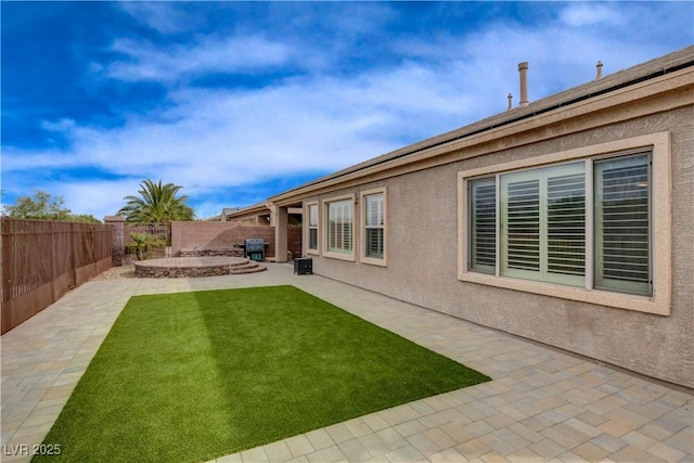 view of yard featuring a patio area and a fenced backyard