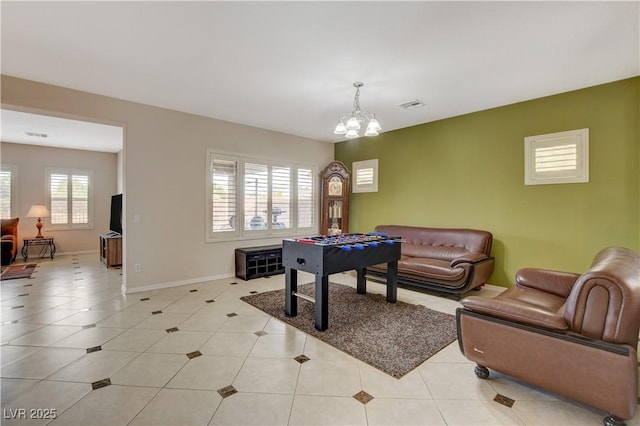 playroom featuring light tile patterned floors, baseboards, visible vents, and an inviting chandelier