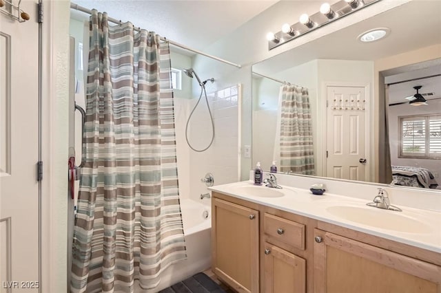 bathroom featuring shower / bath combo, vanity, and ceiling fan