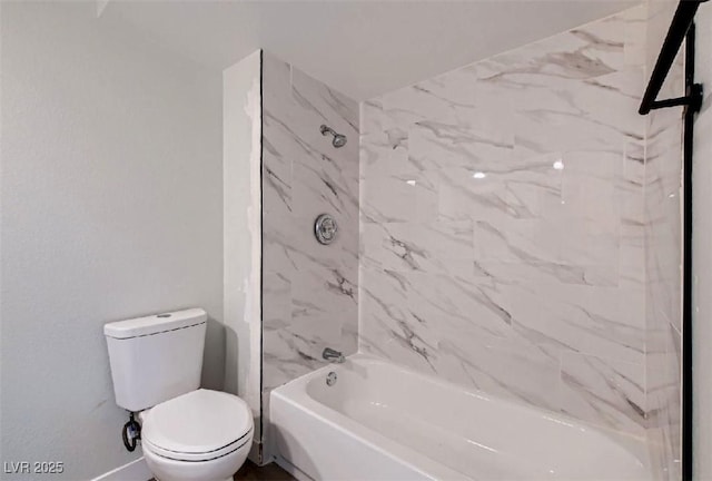 bathroom featuring toilet and tiled shower / bath combo