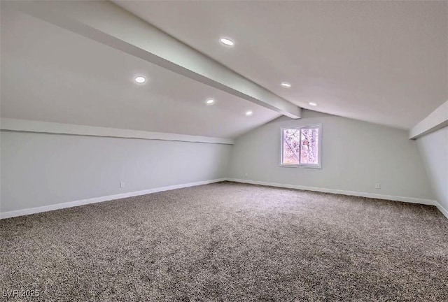 additional living space with carpet floors and vaulted ceiling with beams