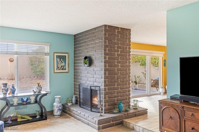 living room with a fireplace and a textured ceiling