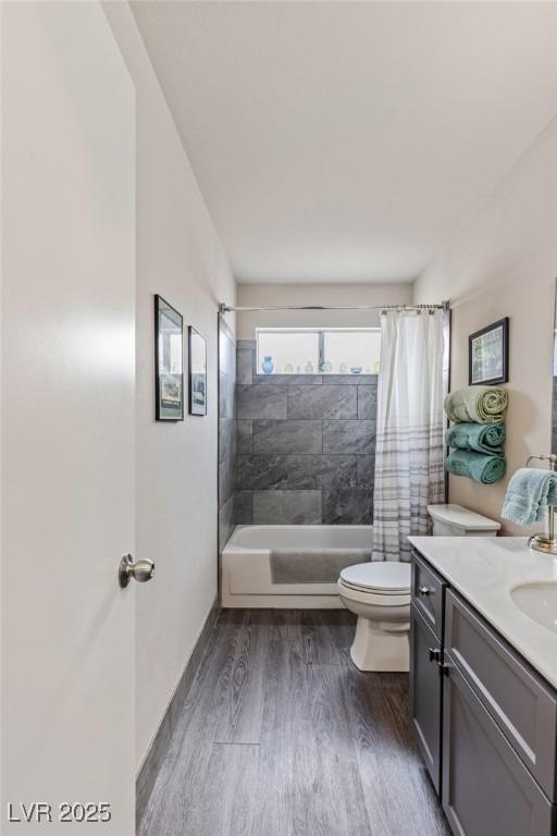 full bathroom with wood-type flooring, toilet, vanity, and shower / bath combo