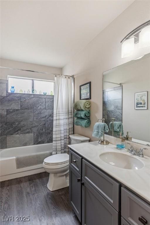 full bathroom featuring hardwood / wood-style flooring, vanity, toilet, and shower / tub combo