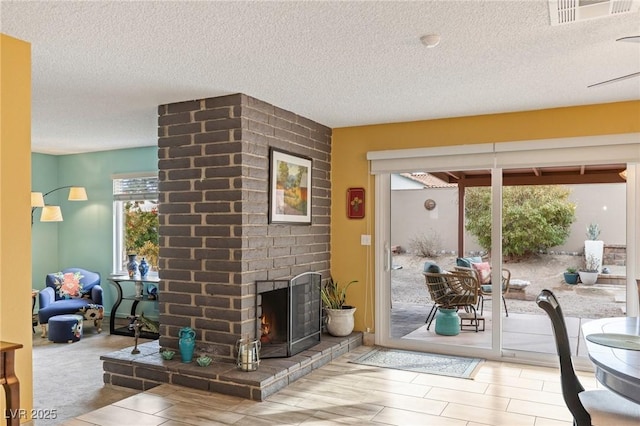 doorway to outside featuring a fireplace and a textured ceiling