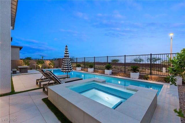 view of swimming pool featuring a patio and an in ground hot tub