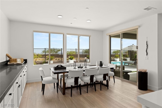 dining room with light wood-type flooring, visible vents, baseboards, and recessed lighting