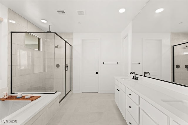 bathroom with vanity and a shower with shower door