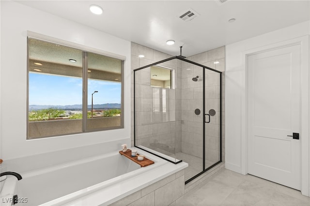 full bathroom featuring visible vents, a shower stall, and a bath