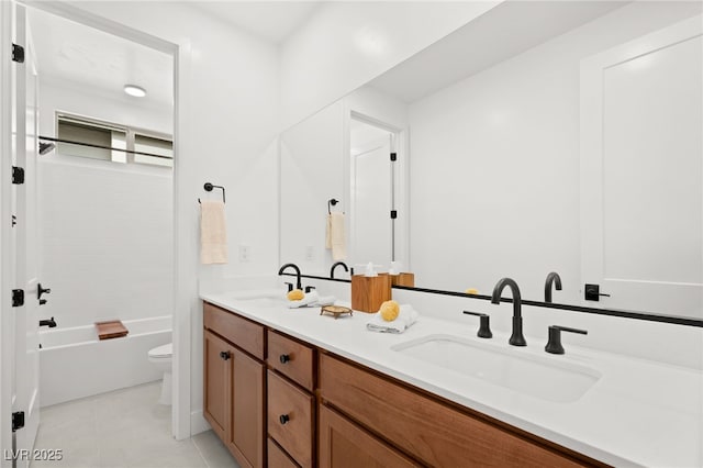 full bathroom featuring washtub / shower combination, vanity, toilet, and tile patterned flooring