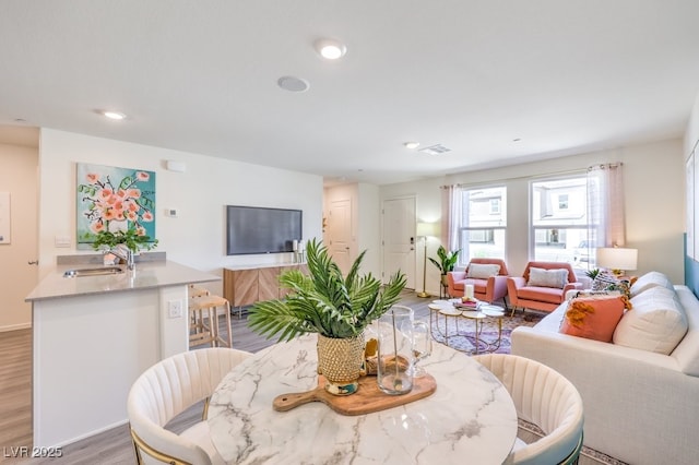 dining area featuring hardwood / wood-style flooring and sink