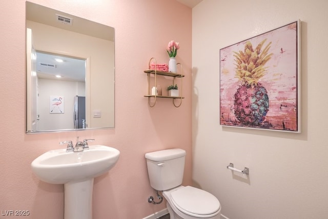 bathroom featuring sink and toilet