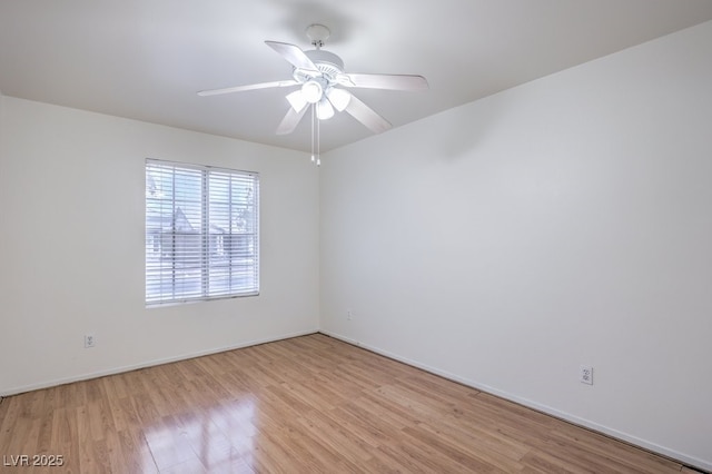 spare room with ceiling fan and light wood-type flooring