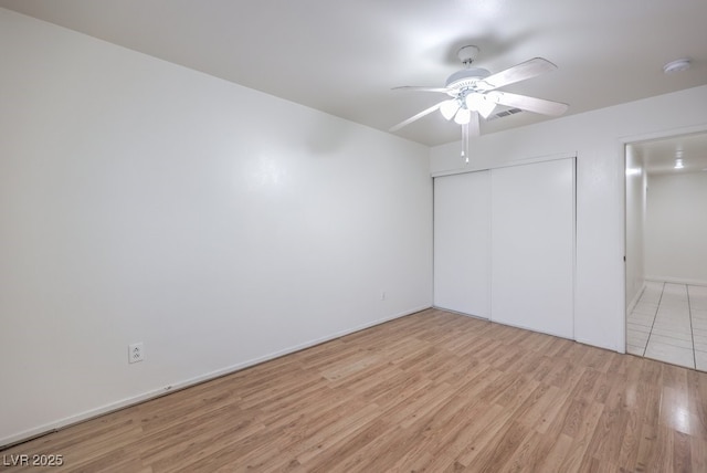 unfurnished bedroom with a closet, ceiling fan, and light hardwood / wood-style flooring