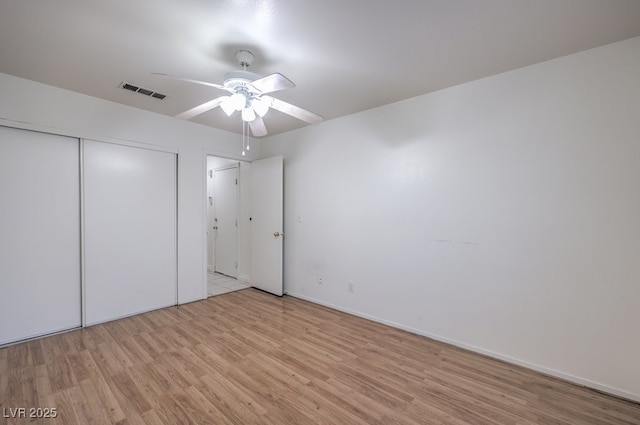 unfurnished bedroom with a closet, ceiling fan, and light hardwood / wood-style flooring