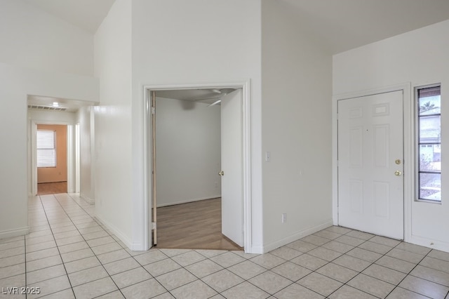 tiled entrance foyer with high vaulted ceiling