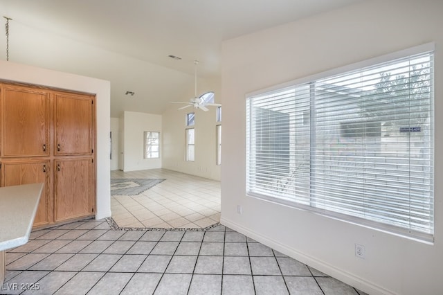 entrance foyer featuring lofted ceiling, light tile patterned floors, and ceiling fan