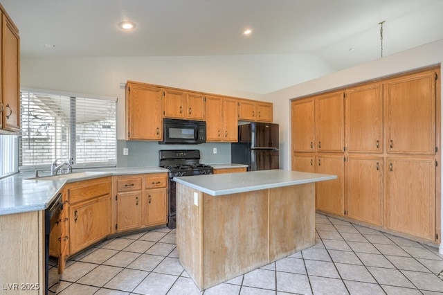 kitchen featuring light tile patterned flooring, vaulted ceiling, sink, a center island, and black appliances