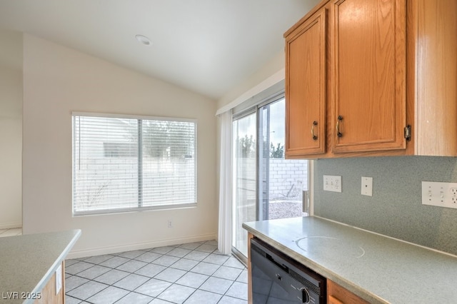 kitchen featuring tasteful backsplash, vaulted ceiling, dishwasher, and light tile patterned flooring