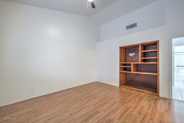 empty room featuring ceiling fan and light wood-type flooring