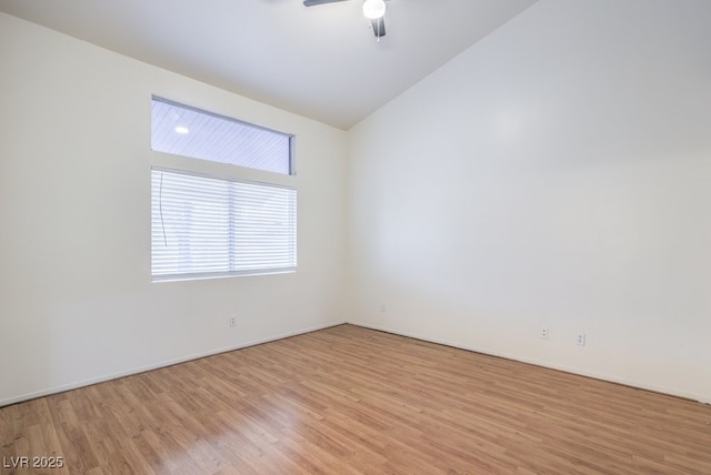 empty room featuring ceiling fan, lofted ceiling, and light hardwood / wood-style floors