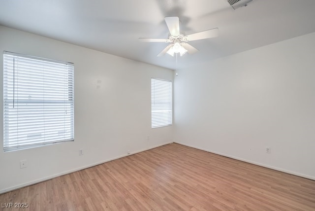 spare room featuring ceiling fan and light hardwood / wood-style floors