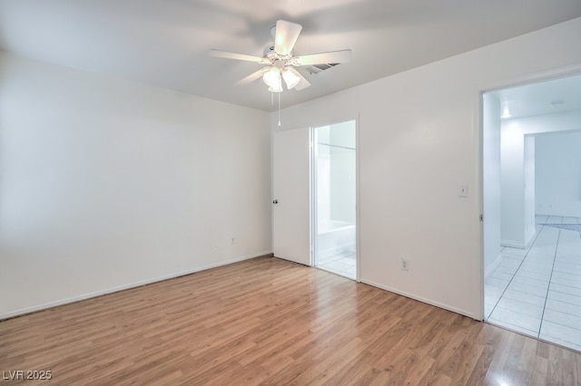 empty room featuring ceiling fan and light wood-type flooring