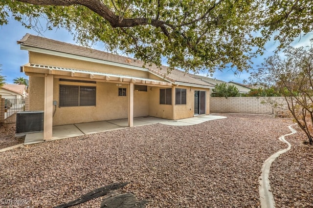 rear view of property with central AC and a patio