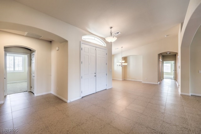 empty room featuring a chandelier