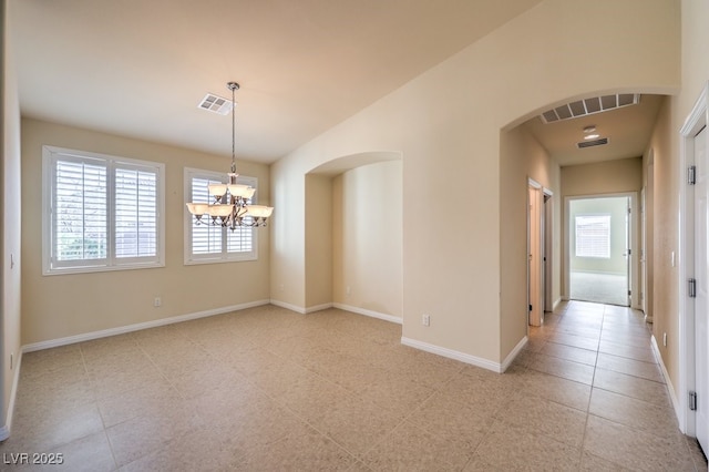 unfurnished dining area with a wealth of natural light, a notable chandelier, and light tile patterned floors