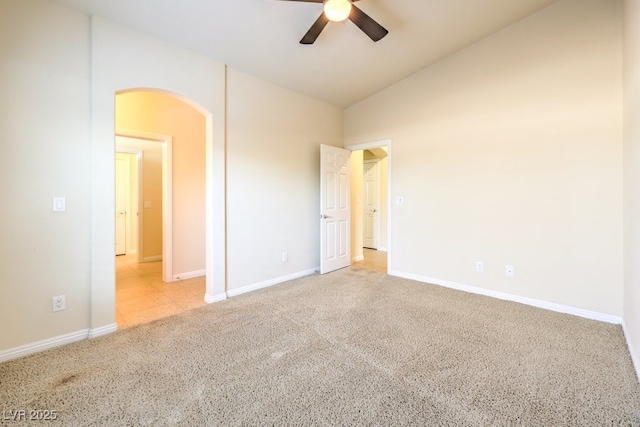 carpeted spare room featuring ceiling fan and high vaulted ceiling