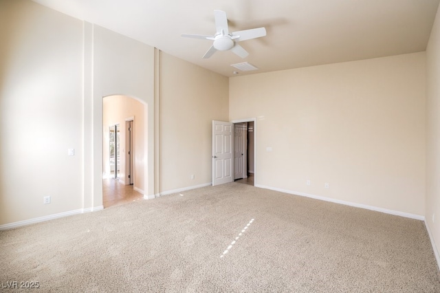 empty room with light carpet, high vaulted ceiling, and ceiling fan