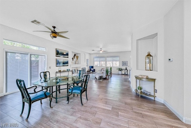 dining area featuring ceiling fan and light wood-type flooring