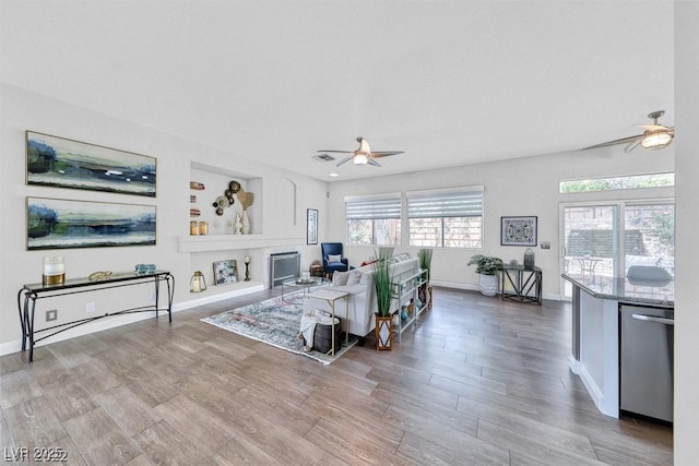 living room with hardwood / wood-style flooring and ceiling fan