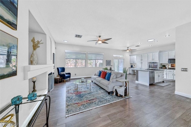 living room featuring hardwood / wood-style flooring and ceiling fan