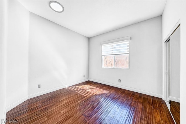 unfurnished bedroom featuring dark hardwood / wood-style floors