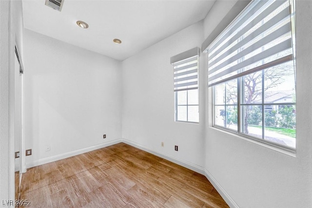 spare room featuring light hardwood / wood-style floors