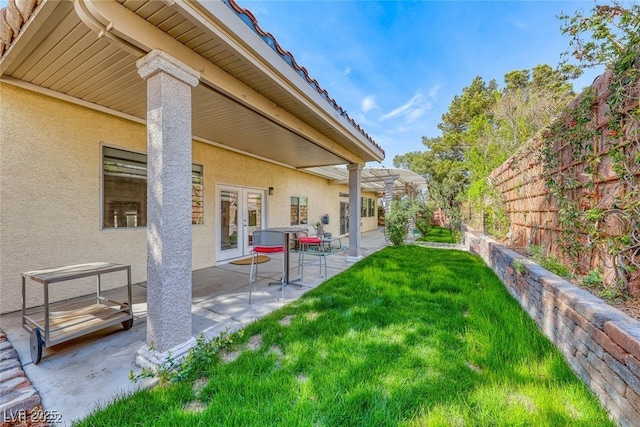 view of yard featuring a patio area and french doors