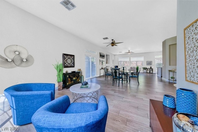 living room with ceiling fan and light hardwood / wood-style floors