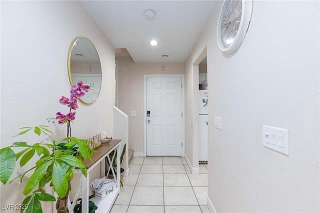 doorway to outside with light tile patterned floors