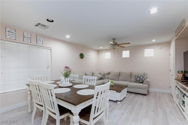 dining area with light hardwood / wood-style floors and ceiling fan