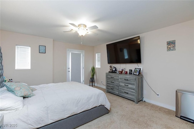 carpeted bedroom with multiple windows and ceiling fan