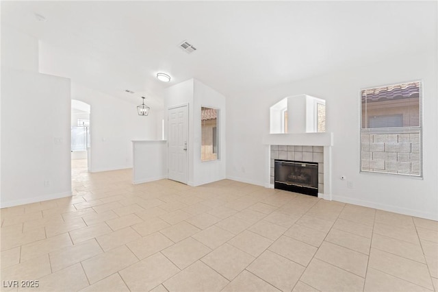 unfurnished living room featuring light tile patterned floors and a fireplace