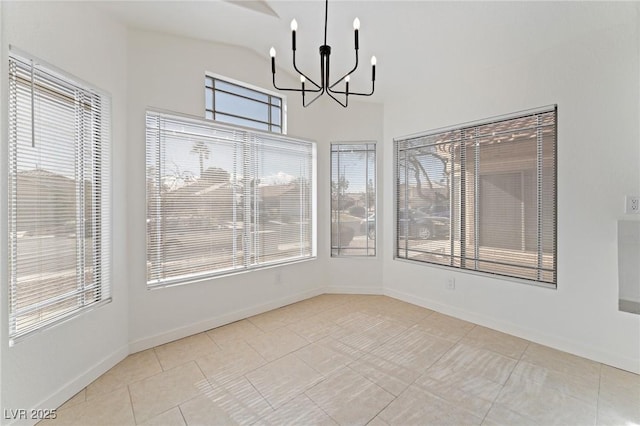 unfurnished sunroom featuring lofted ceiling, a wealth of natural light, and a chandelier