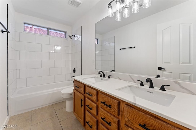 full bathroom featuring tiled shower / bath combo, vanity, tile patterned floors, and toilet