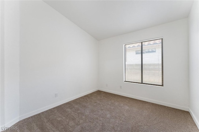 carpeted spare room with lofted ceiling