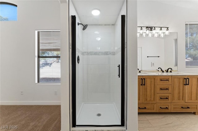 bathroom with a shower with door and vanity